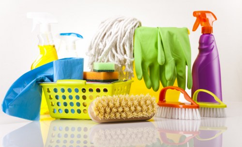 Local cleaner tidying a shared lobby and lift area in Harrow